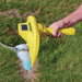 AML pro in yellow being used to find a PVC pipe in grass